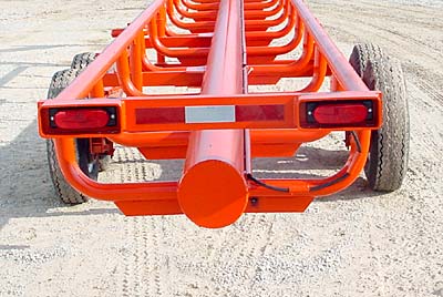 Orange Ox - Orange Ox Self Un-loading Hay Trailers - The tail lights are protected by heavy box tubing and the wiring is protected by schedule 40 pipe. This picture also shows the one piece els (no welds to break), reinforced by �� x 2� flat steel.